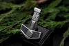 Angled close-up of Norse Mjolnir pendant showing wrapped handle detail, on a dark background.