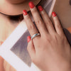 Elegant star ring on woman's hand with flower background – dainty ring photo