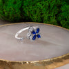 Blue Cubic Zirconia Flower Spinner Ring β Adjustable Silver-Tone Statement Ring for Women