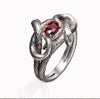 This image reveals the mesmerizing design of the double snake ring, featuring two interwoven serpents. Crafted from oxidized 925 sterling silver, the detailed texture of the snake scales is a testament to the craftsmanship involved. The vibrant red cubic zirconia stone adds a sophisticated pop of color, making this ring an eye-catching statement piece for jewelry enthusiasts.