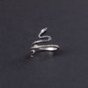 Get a close-up of this dainty sterling silver snake ring, showcasing its intricate design and delicate curves. The smooth sterling silver body wraps around the finger with a refined elegance, embodying a minimalist charm that is perfect for everyday wear. A statement piece in its own right, this ring catches the light beautifully and adds a touch of sophistication to any outfit. Ideal for wearing on the pinky or as a midi ring, this piece is both versatile and stylish.