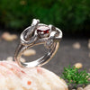 This photo highlights the stunning craftsmanship of the double snake ring. Each snake’s scales and curves are intricately designed, bringing the piece to life with an incredible level of detail. Made from oxidized sterling silver, the ring’s rich texture and the vibrant red cubic zirconia make it a perfect choice for those who appreciate unique, high-quality jewelry that combines elegance with a touch of mystery.