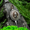 Angled side view of Viking-style Spartan pendant made of sterling silver and exotic wood, photographed outdoors.