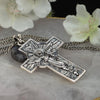 Back side of oxidized silver Jesus cross pendant showing detailed engraving on floral marble