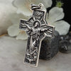 Handcrafted Sterling Silver Jesus Cross Pendant displayed on natural stone background with white flowers