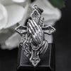 Handmade religious jewelry pendant with praying hands and cross