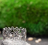 Close-up of silver filigree ring with intricate details, artisan handmade jewelry