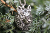 Detailed wolf head necklace among green pine branches, sterling silver totem pendant