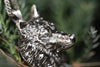 Close-up of oxidized silver wolf pendant, showcasing realistic fur texture and fine craftsmanship