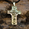 Gold-plated version of Jesus resurrection pendant on rugged stone background, spiritual gift display