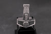 Side view of Viking hammer necklace showing knot and rune symbols on dark stone display.