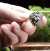 Sterling silver Lion Ring with a unique design, styled with natural elements in the background. This image highlights the ring's symbolism of strength and resilience. A great choice for lion enthusiasts and those born under the Leo zodiac sign.