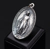 In this elegant display, the Miraculous Medal Necklace is showcased against a velvet background, highlighting the 925 sterling silver's shine and craftsmanship. The velvet adds a luxurious touch, making the pendant perfect for gifting on special occasions like First Communions, Confirmations, or religious holidays. This necklace is not only a piece of jewelry but also a spiritual treasure to cherish for a lifetime.
