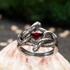 This close-up focuses on the captivating red cubic zirconia, symbolizing energy and passion. The deep hue of the stone contrasts beautifully with the oxidized silver, giving this ring a dramatic look that’s perfect for lovers of gothic style. This ring is made to be admired for its color and character.