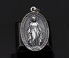 A close-up side view of the Miraculous Medal Necklace displays the pendant's exquisite detailing and quality craftsmanship. The thickness and boldness of the design ensure durability while maintaining elegance. The 925 sterling silver material ensures the pendant will last for generations, and its timeless design makes it perfect for anyone looking to express their faith in style. Wear this medal as a daily reminder of your devotion or gift it to a loved one for a special occasion.