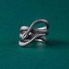 This photo captures the intricate coiled design of the sterling silver snake ring, showcasing the careful craftsmanship and attention to detail. The textured scales reflect light beautifully, giving the ring a realistic and captivating look. Perfect for anyone seeking bold, symbolic jewelry that stands out, this unique piece embodies strength and mystery, making it an essential addition to any statement ring collection.