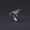 This photo highlights the textured detail of the snake’s skin, adding depth and character to the ring’s design. The craftsmanship in this piece allows the silver to mimic the natural scales of a snake, creating a look that is both fierce and elegant. This detail brings out the ring’s uniqueness, making it an ideal gift for those who appreciate fine jewelry with a story.