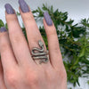 This adjustable sterling silver snake ring is designed with intricate detailing, showcasing the serpent's powerful and mysterious essence. Its adjustable feature makes it a versatile piece that fits various sizes, offering both comfort and style. A bold choice for gothic and statement jewelry enthusiasts.