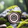 Exclusive silver superhero pendant styled outdoors on natural moss and stone – nature-inspired setting