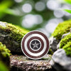 Close-up of pendant placed on moss with soft natural bokeh background – handcrafted detail