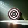 Sterling silver shield pendant illuminated by dramatic light beams – symbolic and powerful