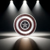 Silver superhero pendant reflecting light in studio – minimalist yet striking visual