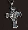 Handmade Christian cross pendant with Jesus image shown in studio lighting for spiritual jewelry presentation