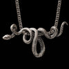 Bold sterling silver snake pendant in the shape of a coiled serpent on a black background – handcrafted 925 silver statement necklace