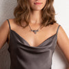 Sterling silver snake pendant necklace styled for elegant evening wear – spiritual and wild animal jewelry