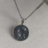 360 view of handmade silver pendant with wolves and moon, detailed and textured surface